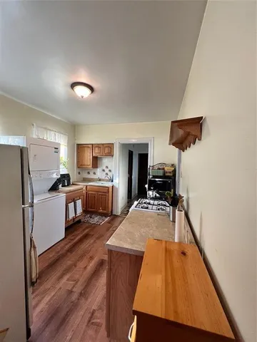 a kitchen with sink refrigerator and stove