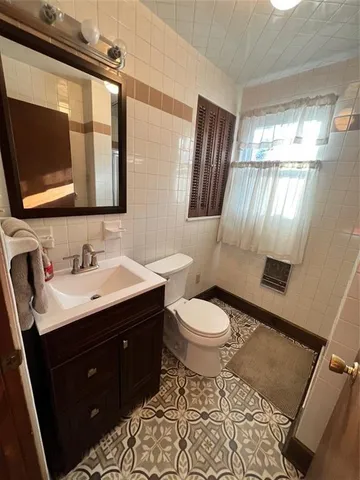 a bathroom with a sink toilet and mirror