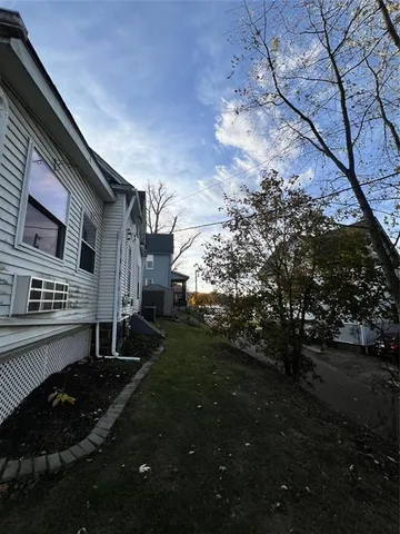 a view of a house with backyard and garden