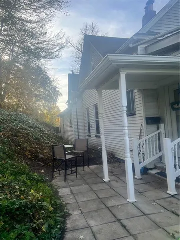 a view of a house with backyard and sitting area