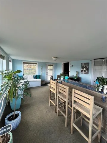 a living room with furniture a window and a flat screen tv