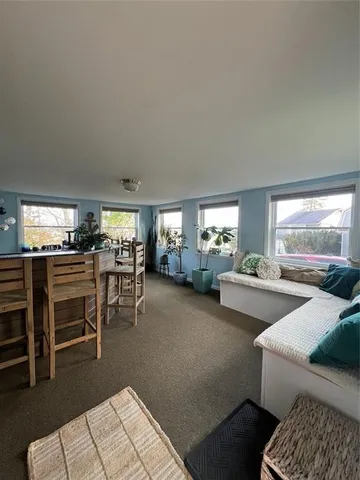 a living room with furniture and view of couch