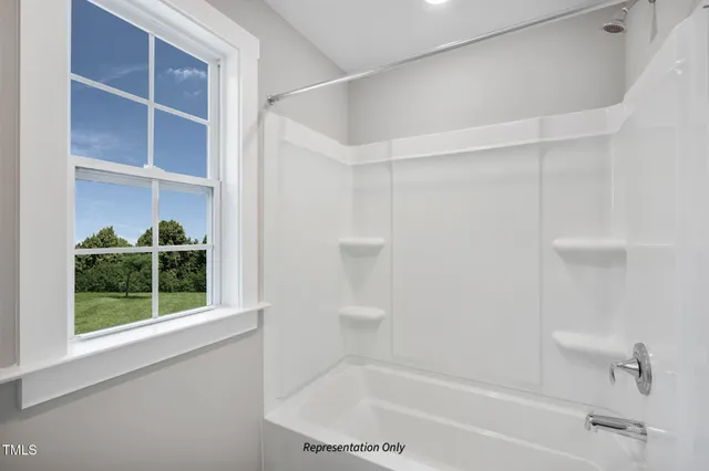 a bathroom with a tub and a shower