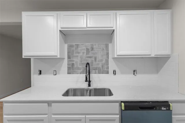 a kitchen with a sink and cabinets