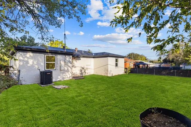 a view of a house with a backyard