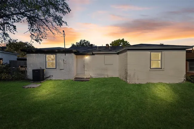a backyard of a house with table and chairs