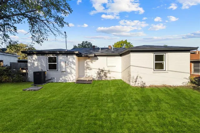 a view of a backyard with plants and a garden