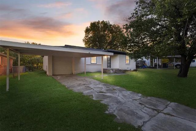a view of an house with backyard space and garden