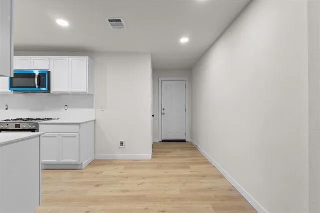 a view of a kitchen with a sink and a stove top oven