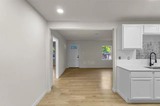 a view of a kitchen with a sink and dishwasher wooden floor