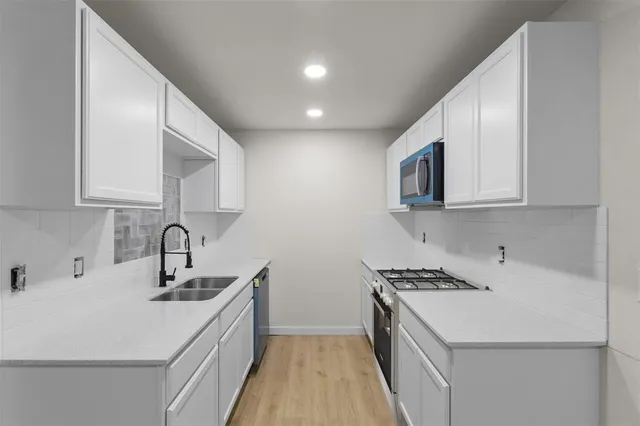 a kitchen that has a sink and a stove