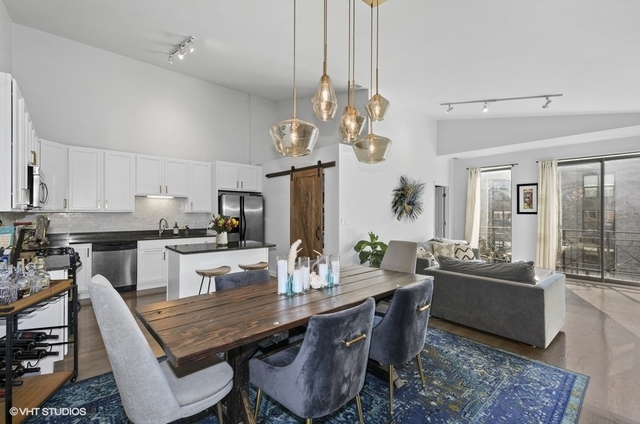 Undisclosed Address Chicago, IL 60647 - Photo 11 of 26 a dining room with wooden floor and chandelier
