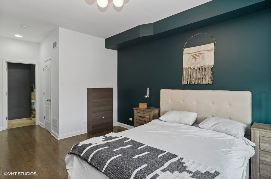 Undisclosed Address Chicago, IL 60647 - Photo 13 of 26 a bedroom with a bed and wooden floor