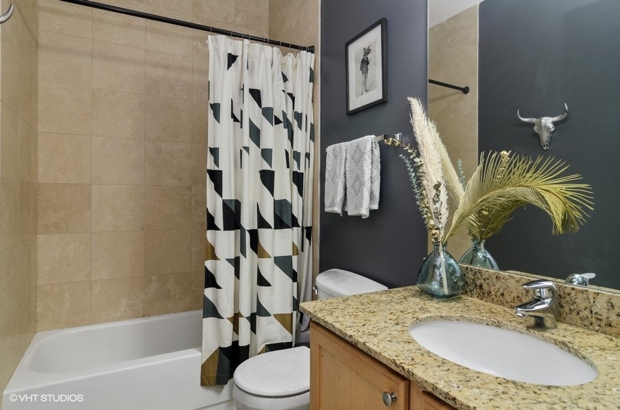 Undisclosed Address Chicago, IL 60647 - Photo 17 of 26 a bathroom with a granite countertop sink toilet and shower