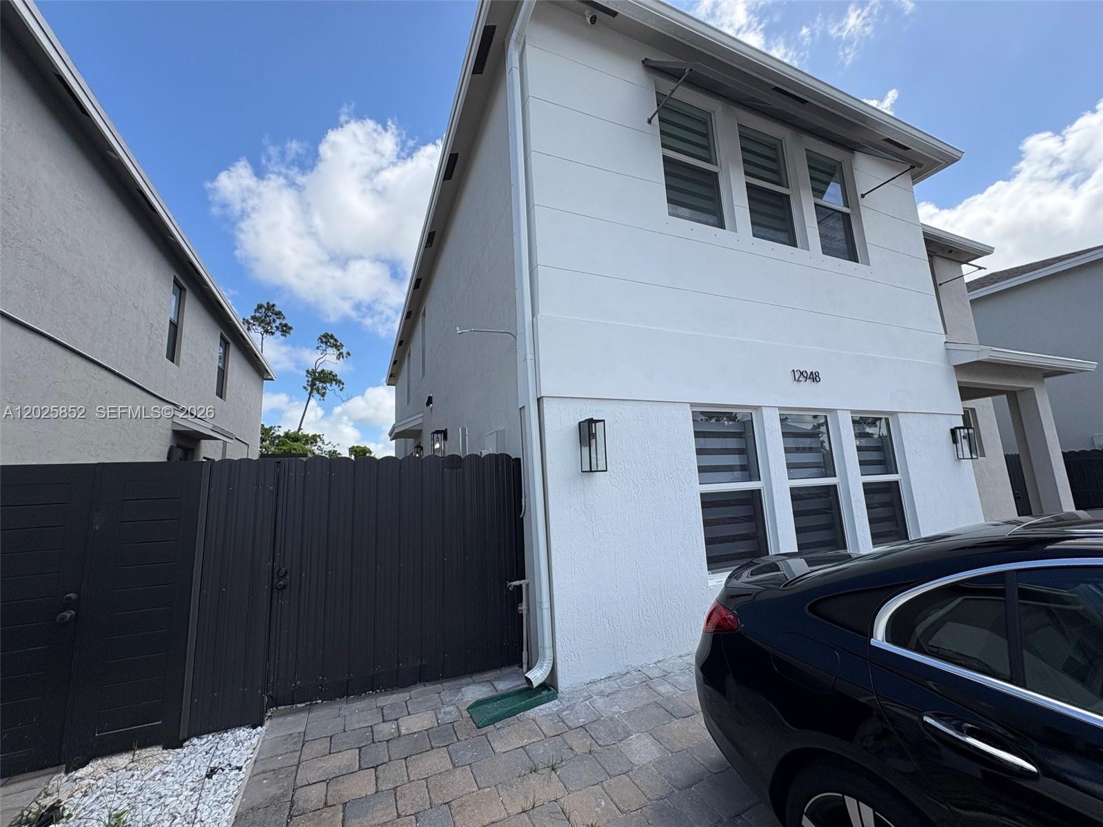 12948 Southwest 265th Terrace, Unit STUDIO Homestead, FL 33032 - Photo 3 of 16 a front view of a house