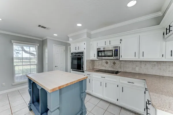 a bathroom with a granite countertop sink a toilet and shower