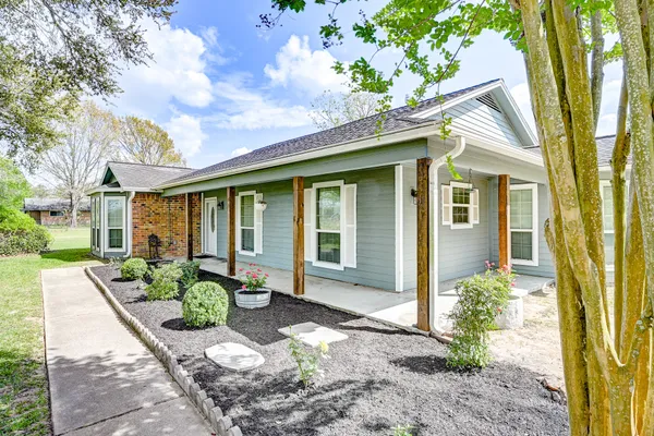 a front view of a house with a garden
