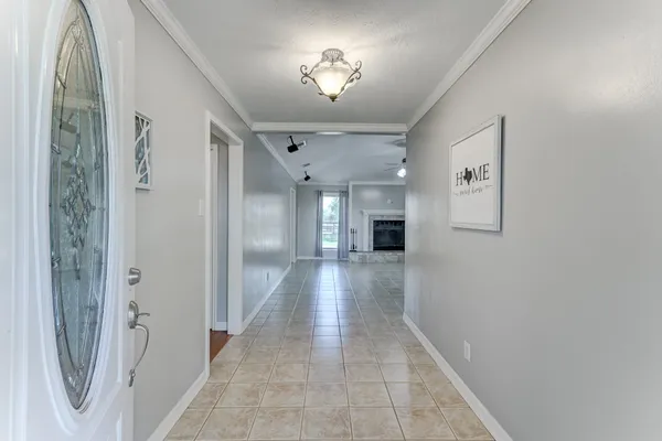 a large white kitchen with cabinets