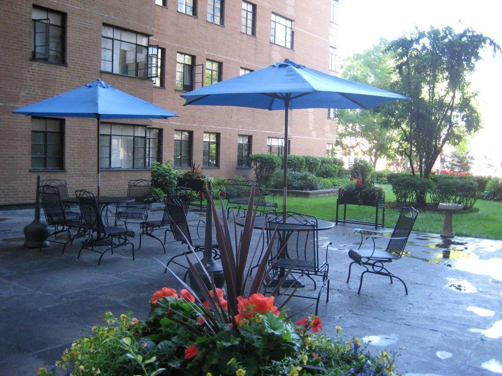 5630 North Sheridan Road, Unit 1205 Chicago, IL 60660 - Photo 3 of 7 a patio with a table and chairs under an umbrella