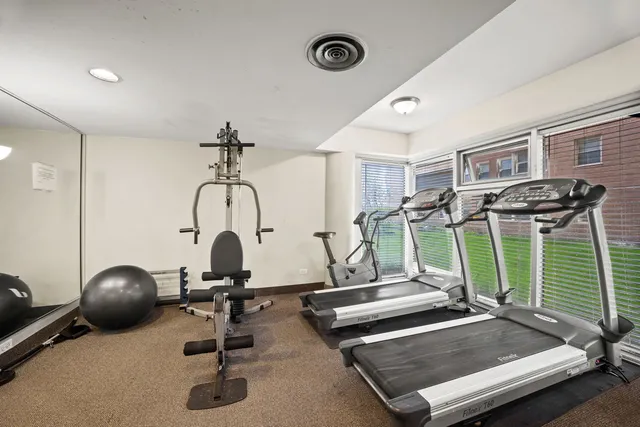 a room with gym equipment and windows