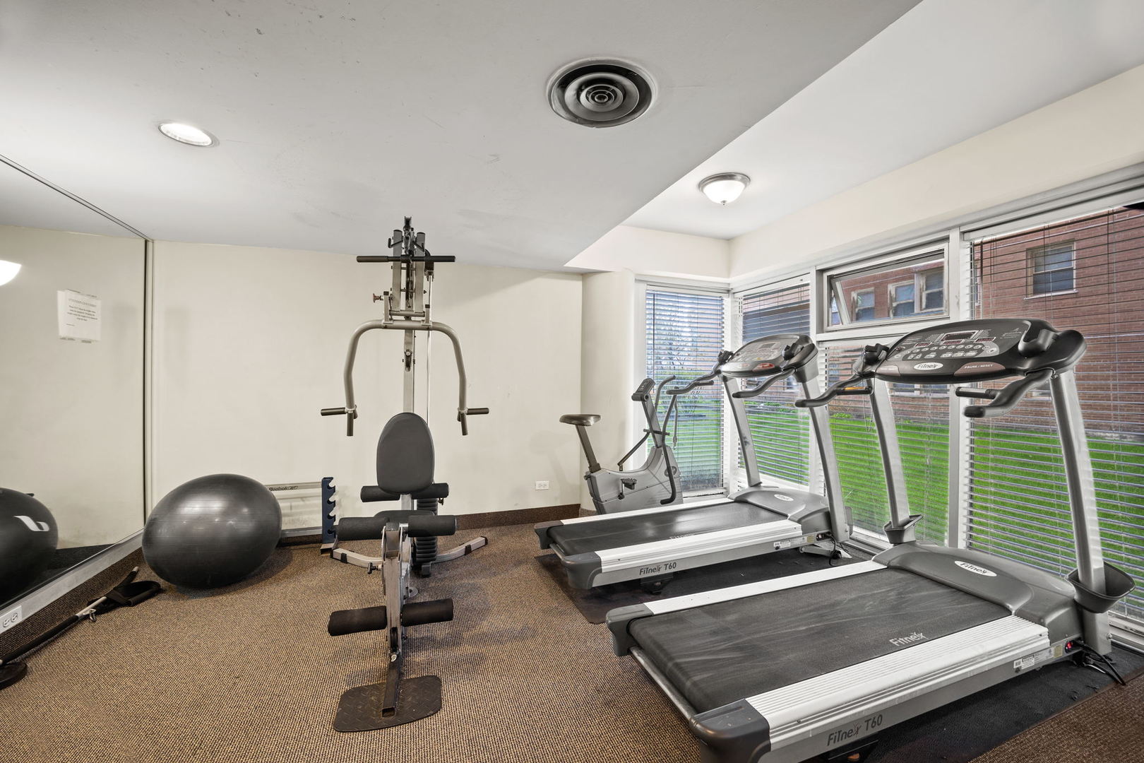 5630 North Sheridan Road, Unit 1205 Chicago, IL 60660 - Photo 4 of 7 a room with gym equipment and windows