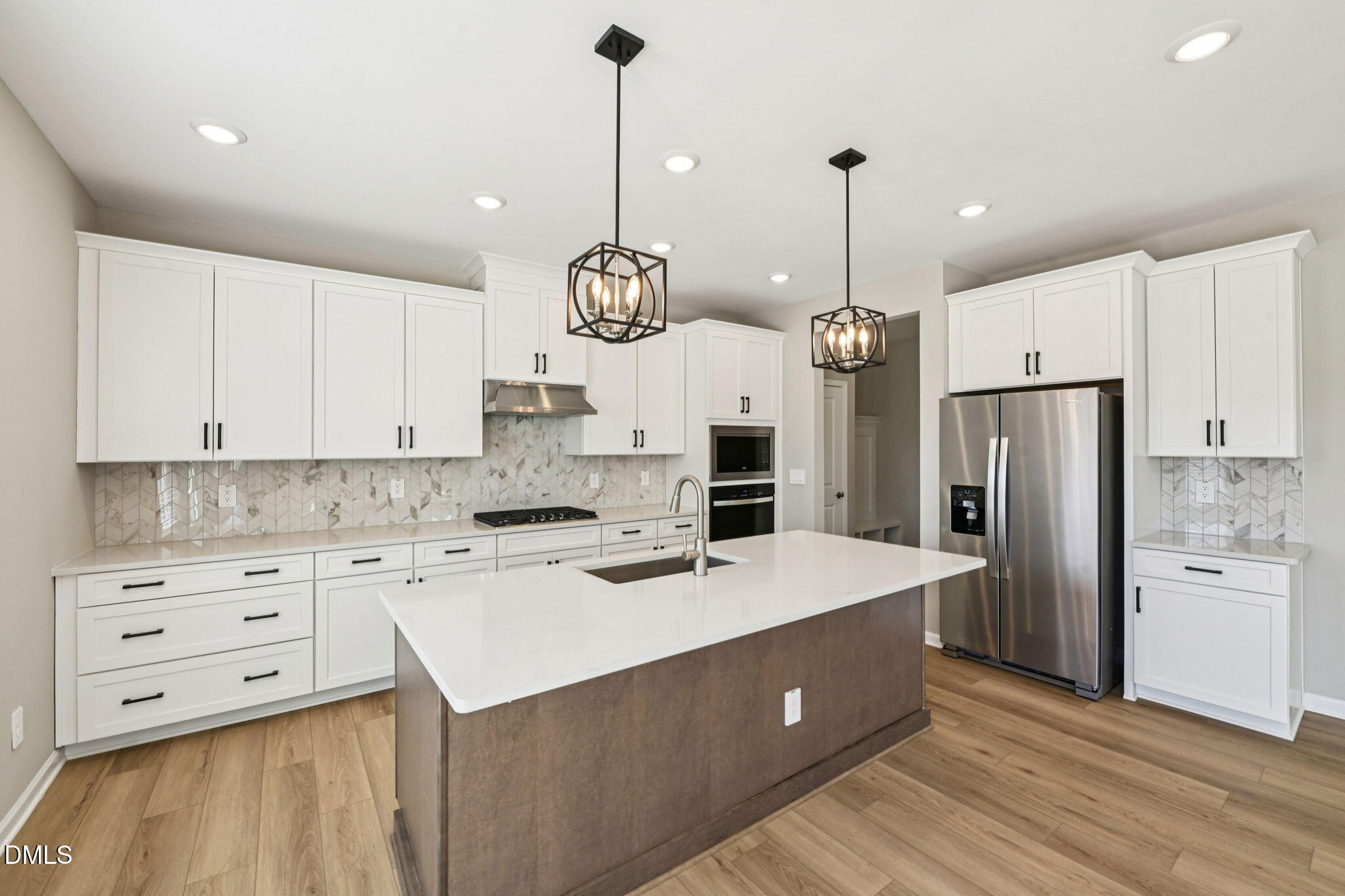 a kitchen with a refrigerator a sink and cabinets