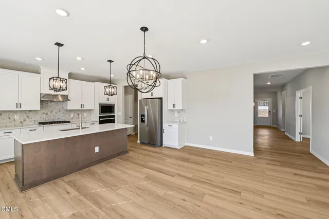 a view of a kitchen with a sink and a stove top oven