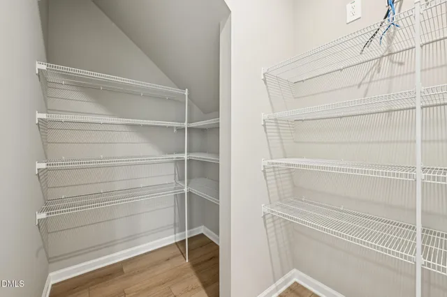 a kitchen with stainless steel appliances granite countertop a sink a stove and a wooden floors