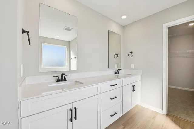 a bathroom with a double vanity sink mirror and