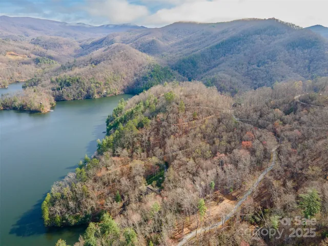 a view of a houses with a lush green hillside