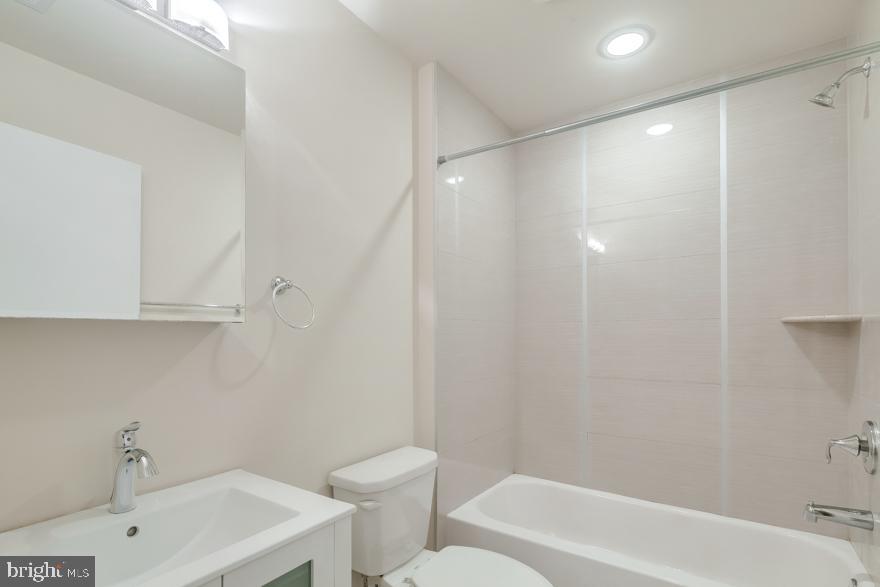 1430 South Street, Unit 403 Philadelphia, PA 19146 - Photo 6 of 9 a bathroom with a sink a toilet and shower