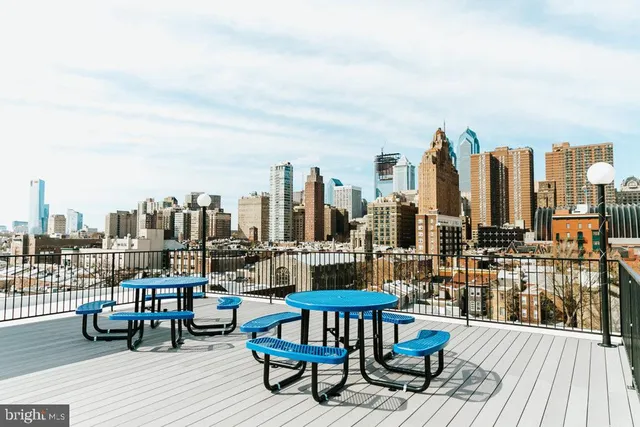 a view of a terrace with wooden benches