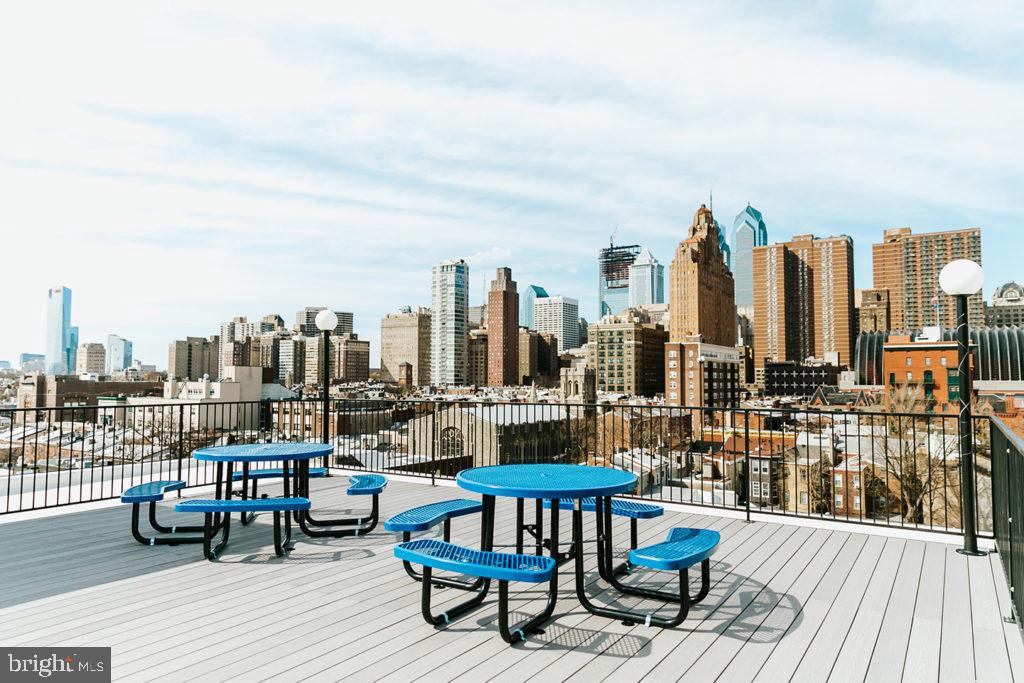 1430 South Street, Unit 403 Philadelphia, PA 19146 - Photo 7 of 9 a view of a terrace with wooden benches