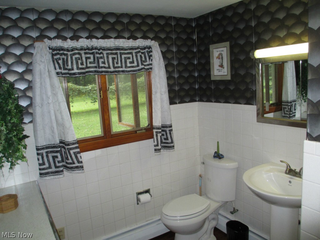12154 West Ridge Road Oberlin, OH 44074 - Photo 10 of 24 Remodeled bath boasts a new toilet and pedestal sink.