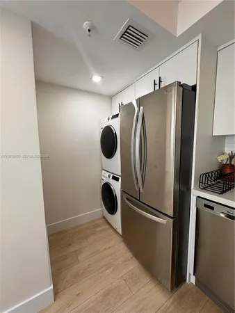 a kitchen with refrigerator a washer and dryer