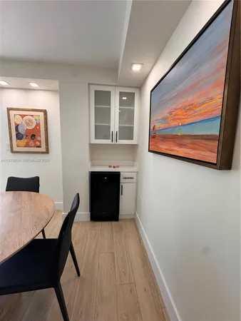 a view of a workspace with furniture and wooden floor