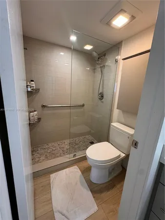 a bathroom with a toilet and a shower