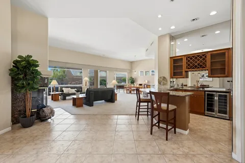 a living room with couches a dining table kitchen view and living room view
