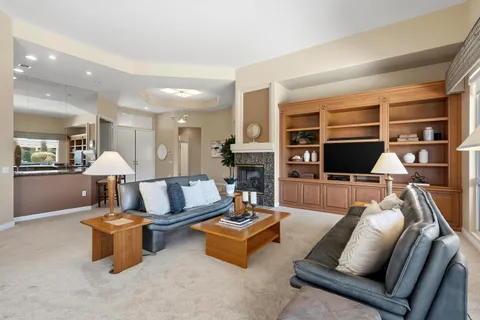 a living room with furniture or wooden floor and a flat screen tv