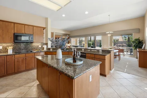 a kitchen with stainless steel appliances granite countertop a stove sink and cabinets