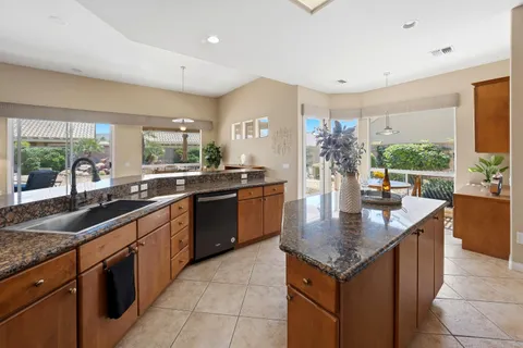 a kitchen with granite countertop counter space a sink appliances and cabinets