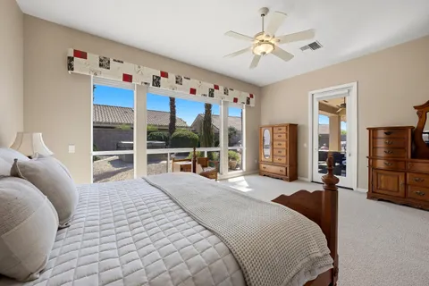 a bedroom with a large bed and a chandelier