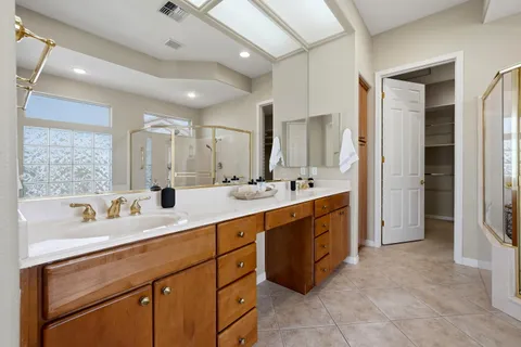 a spacious bathroom with a double vanity sink mirror and double