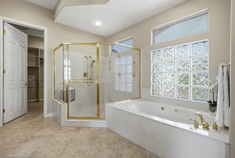 a bathroom with a bathtub shower and a sink