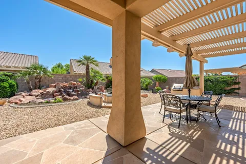 a view of a patio with table and chairs and potted plants