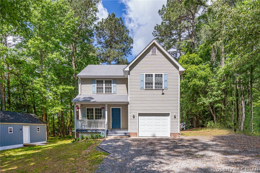9313 South Courthouse Road Providence Forge, VA 23140 - Photo 3 of 35 a front view of a house with a yard and garage