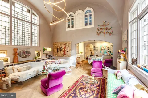 a bedroom with furniture and a large window