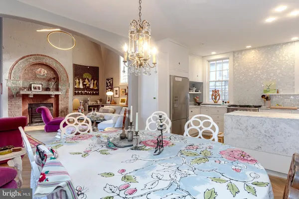 a kitchen with granite countertop a stove a sink and a refrigerator