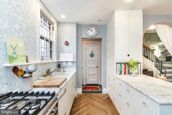 a kitchen with stainless steel appliances granite countertop a stove and a sink