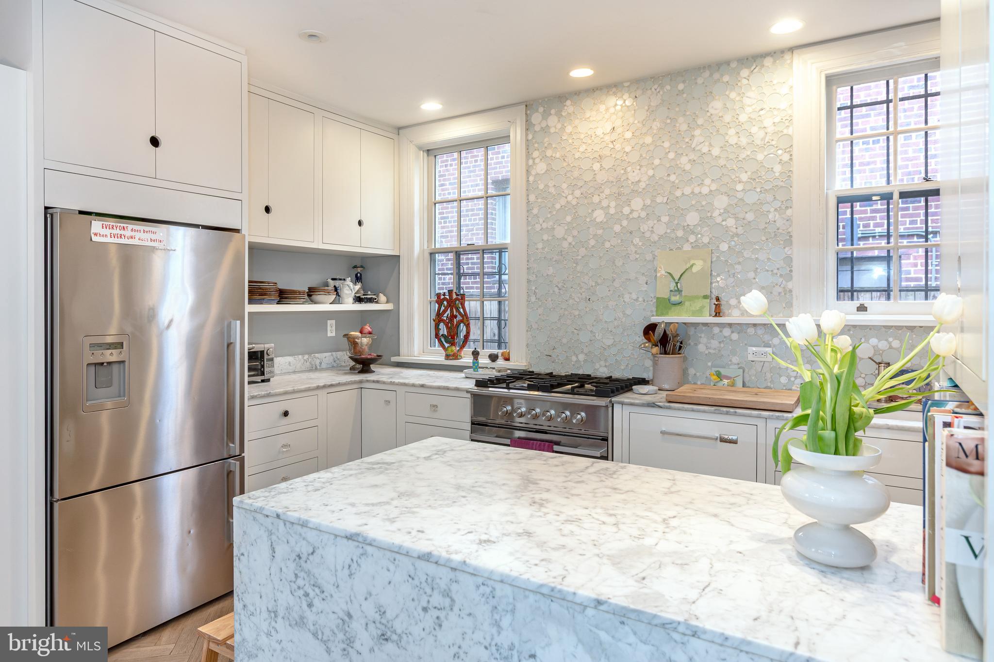 2633 15th Street Northwest, Unit 3 Washington, DC 20009 - Photo 17 of 53 a kitchen with stainless steel appliances a refrigerator sink and white cabinets
